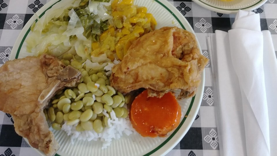 Warm buffet setup with seafood and comfort foods.
