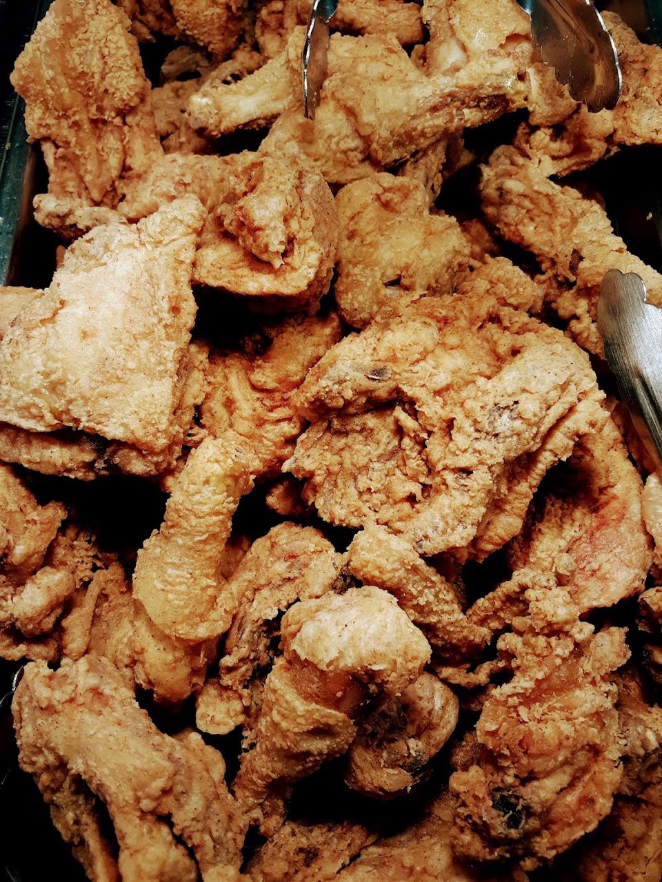 Buffet menu featuring fried fish and collard greens.